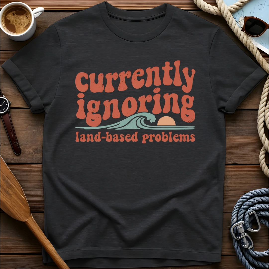 T-shirt with a retro scene of a person relaxing in a boat and text reading 'Those Sound Like Land Problems.'