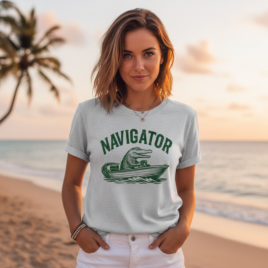 Woman wearing a 'Navigator' t-shirt on a beach at sunset