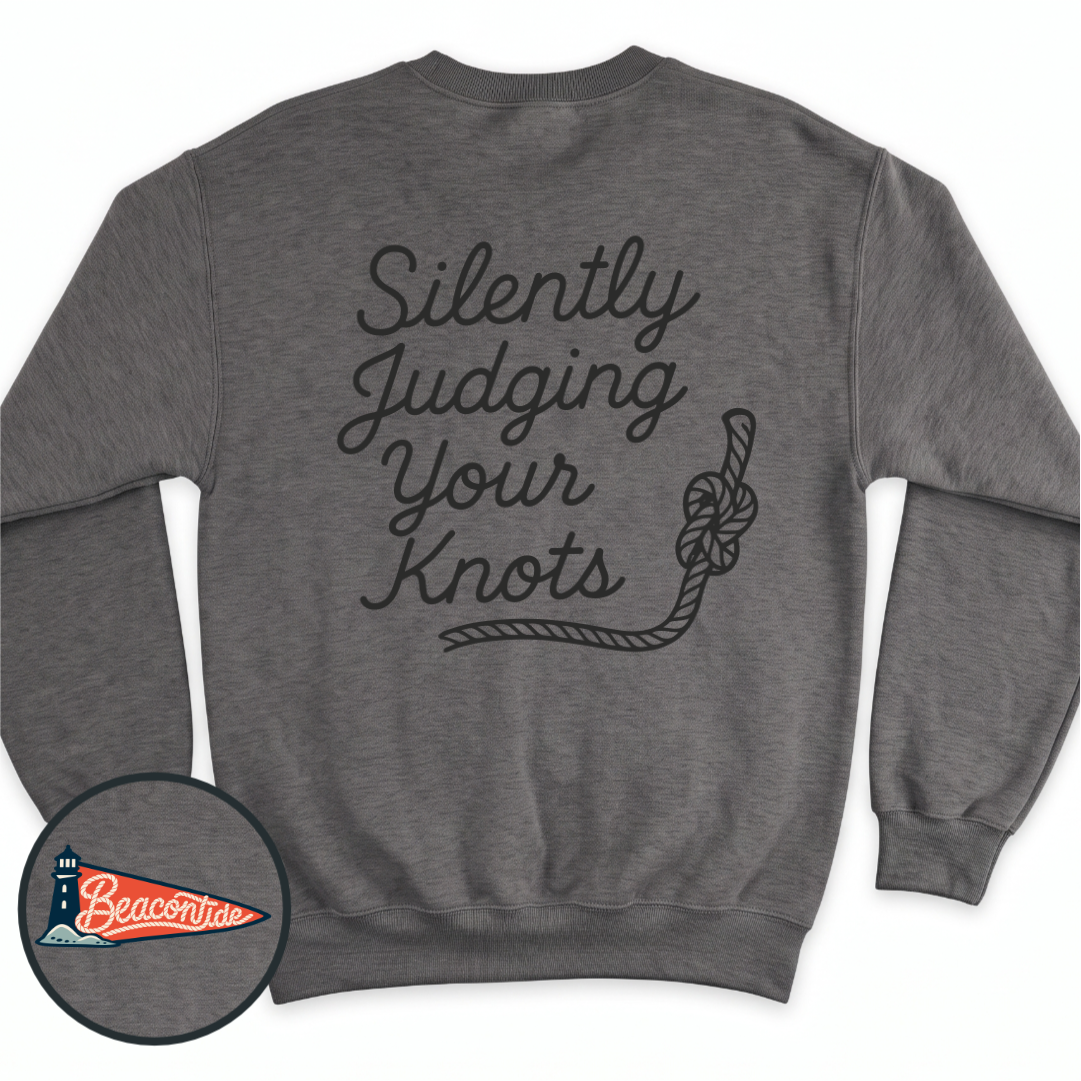 Silently Judging Knots crewneck sweatshirt in Dark Heather, back view — script lettering Silently Judging Your Knots with a knotted rope, BeaconTide