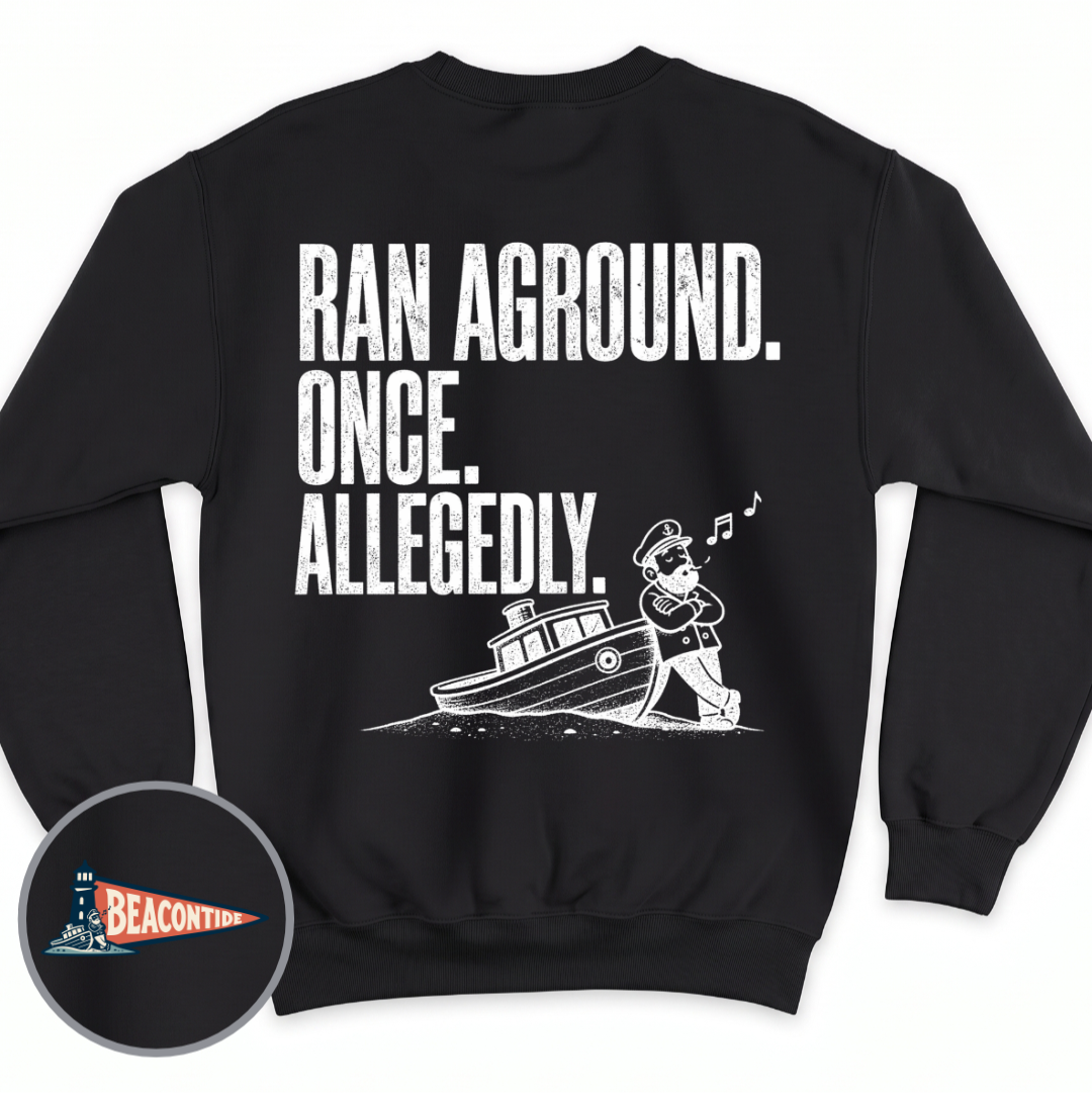 Allegedly Ran Aground crewneck sweatshirt in Black, back view — Ran Aground. Once. Allegedly. with a captain leaning on a grounded boat, BeaconTide