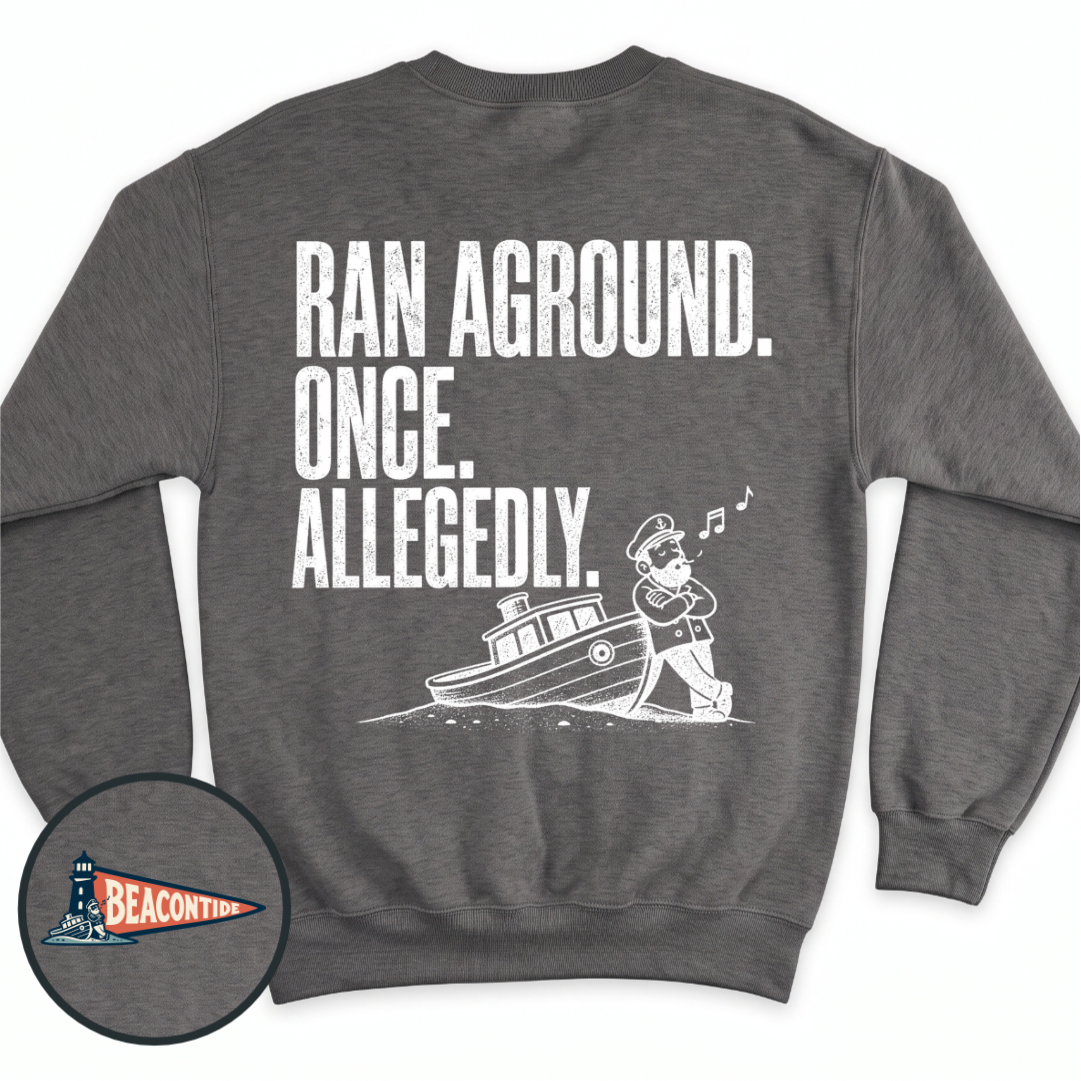 Allegedly Ran Aground crewneck sweatshirt in Dark Heather, back view — Ran Aground. Once. Allegedly. with a captain leaning on a grounded boat, BeaconTide